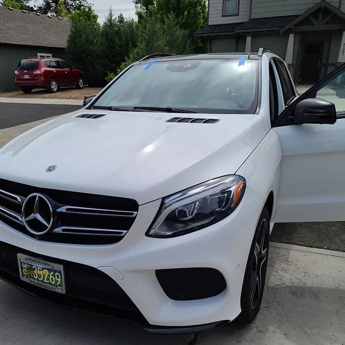 Newly installed front windshield on a Mercedes SUV.